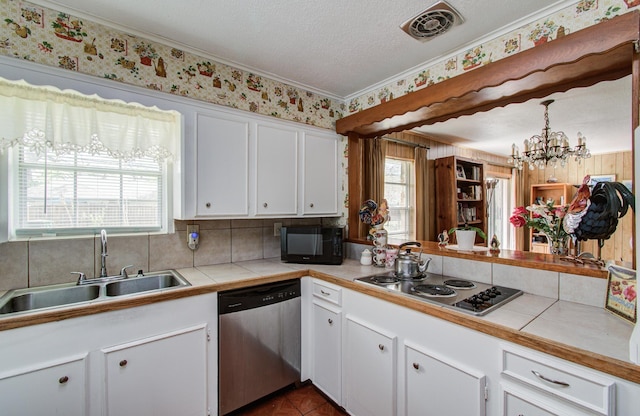 8503 Mcavoy Dr, Houston, TX 77074 - kitchen with visible vents, a healthy amount of sunlight, tile countertops, appliances with stainless steel finishes, and a sink