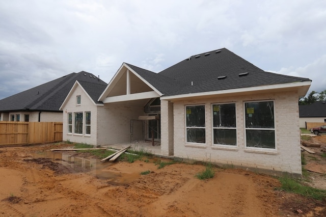 9710 Falling Leaf Dr, Missouri City, TX 77459 - back of property featuring brick siding, a patio, and roof with shingles