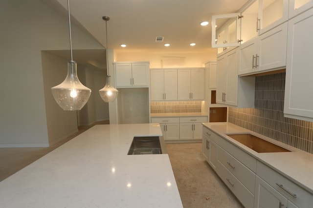9710 Falling Leaf Dr, Missouri City, TX 77459 - kitchen featuring recessed lighting, white cabinets, backsplash, glass insert cabinets, and pendant lighting