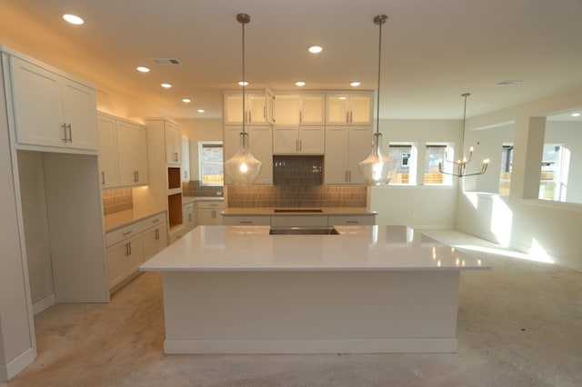 9710 Falling Leaf Dr, Missouri City, TX 77459 - kitchen with decorative backsplash, recessed lighting, white cabinets, and a large island