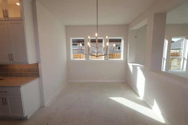 9710 Falling Leaf Dr, Missouri City, TX 77459 - unfurnished dining area with a chandelier and baseboards