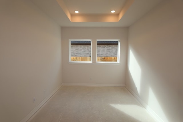 9710 Falling Leaf Dr, Missouri City, TX 77459 - unfurnished room featuring concrete flooring, a tray ceiling, and recessed lighting
