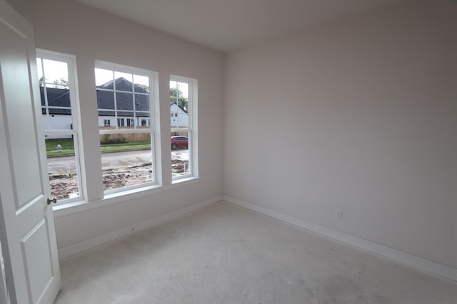 9710 Falling Leaf Dr, Missouri City, TX 77459 - empty room with unfinished concrete floors and baseboards