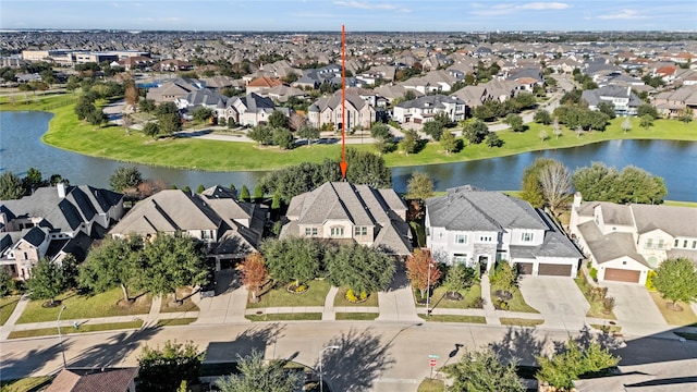 bird's eye view featuring a water view and a residential view