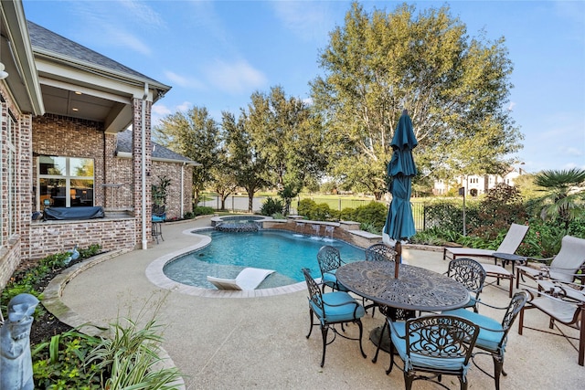 view of swimming pool with a patio area and a pool with connected hot tub