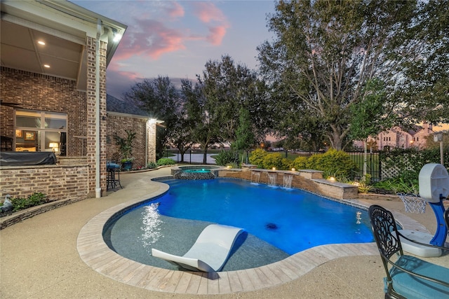 pool at dusk featuring a patio, a pool with connected hot tub, outdoor dry bar, and fence