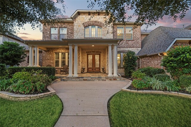 27402 Hollow Pass Ln, Katy, TX 77494 - property entrance featuring covered porch, brick siding, and stone siding