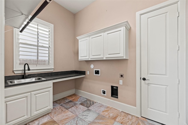 laundry room featuring hookup for an electric dryer, baseboards, hookup for a washing machine, cabinet space, and a sink
