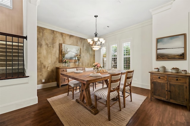 dining space with dark wood-type flooring, an inviting chandelier, baseboards, and ornamental molding