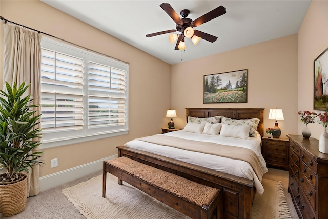 carpeted bedroom with baseboards and ceiling fan