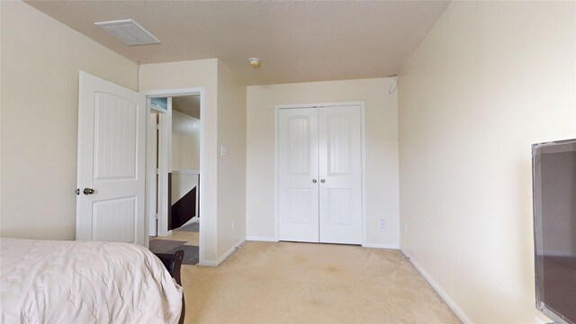 2202 Tandy Park Way, Houston, TX 77047 - bedroom featuring baseboards, visible vents, a closet, and light carpet