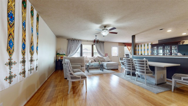 2202 Tandy Park Way, Houston, TX 77047 - living room featuring baseboards, a textured ceiling, a ceiling fan, and wood finished floors