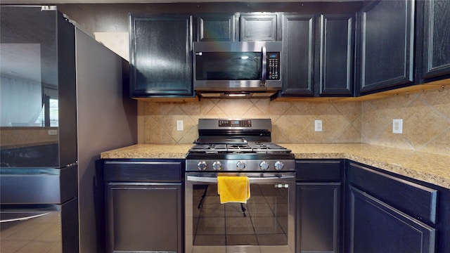 2202 Tandy Park Way, Houston, TX 77047 - kitchen with stainless steel appliances, decorative backsplash, and light countertops