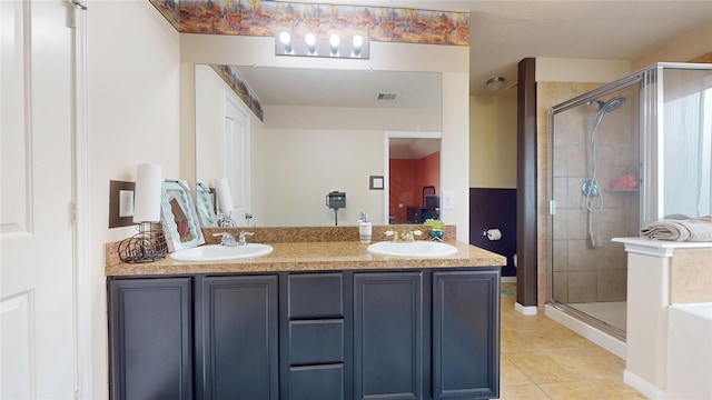 2202 Tandy Park Way, Houston, TX 77047 - bathroom featuring tile patterned floors, visible vents, a stall shower, and a sink