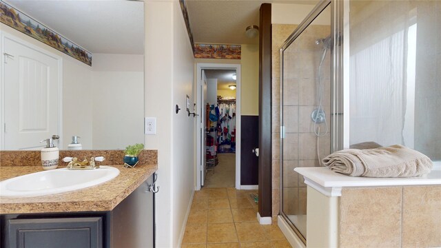 2202 Tandy Park Way, Houston, TX 77047 - bathroom featuring a spacious closet, tile patterned flooring, a stall shower, and vanity