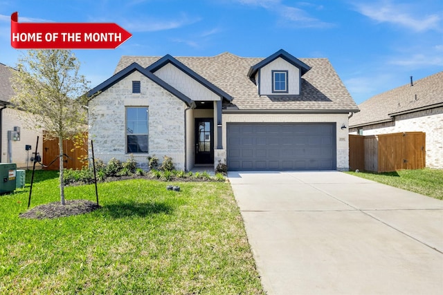 view of front of home featuring a shingled roof, fence, a front yard, driveway, and an attached garage