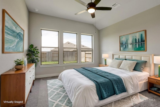 bedroom featuring a ceiling fan, carpet, visible vents, baseboards, and vaulted ceiling