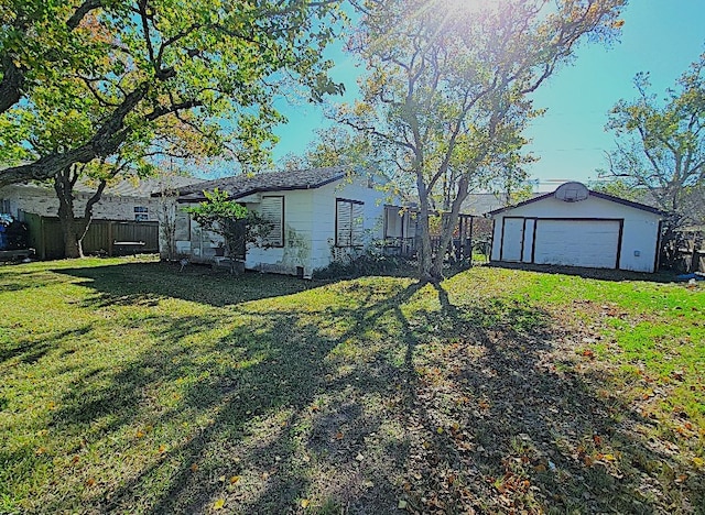 view of yard featuring an outdoor structure and fence
