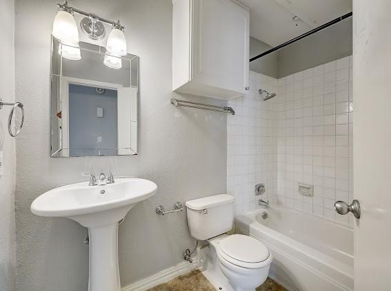 2425 Augusta Dr Unit 60, Houston, TX 77057 - full bath with toilet, baseboards, shower / tub combination, and a sink