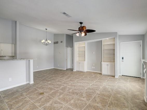 2425 Augusta Dr Unit 60, Houston, TX 77057 - unfurnished living room with ceiling fan, a chandelier, and baseboards