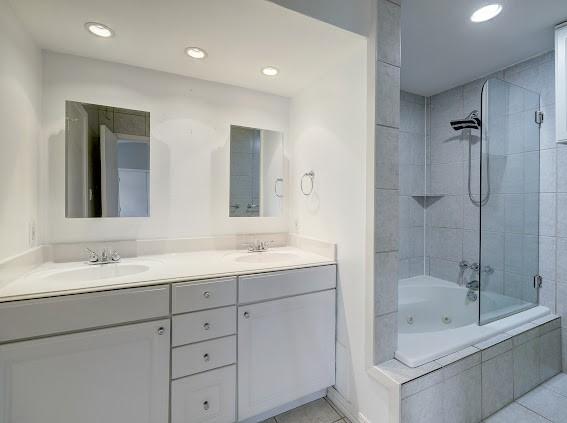 2425 Augusta Dr Unit 60, Houston, TX 77057 - bathroom featuring tile patterned flooring, double vanity, recessed lighting, and a combined bath / shower with jetted tub