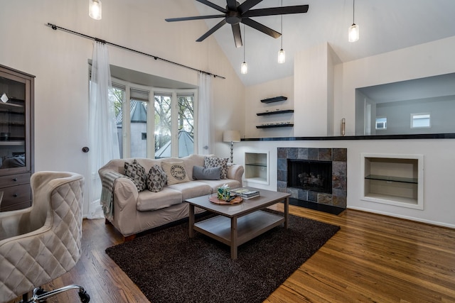 1395 Arlington St Unit 1395, Houston, TX 77008 - living area featuring a ceiling fan, wood finished floors, high vaulted ceiling, built in features, and a fireplace