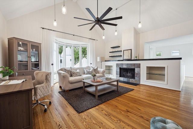 1395 Arlington St Unit 1395, Houston, TX 77008 - living area with high vaulted ceiling, wood finished floors, a ceiling fan, a fireplace, and built in features