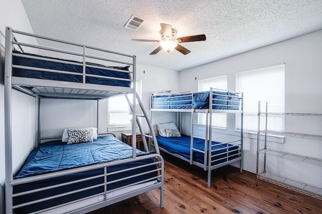 140 Ocean View Dr, Crystal Beach, TX 77650 - bedroom featuring wood finished floors, a textured ceiling, and ceiling fan