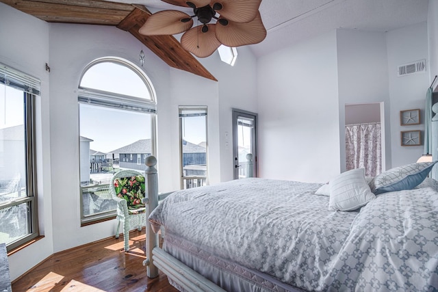 140 Ocean View Dr, Crystal Beach, TX 77650 - bedroom featuring wood finished floors, multiple windows, a skylight, high vaulted ceiling, and ceiling fan