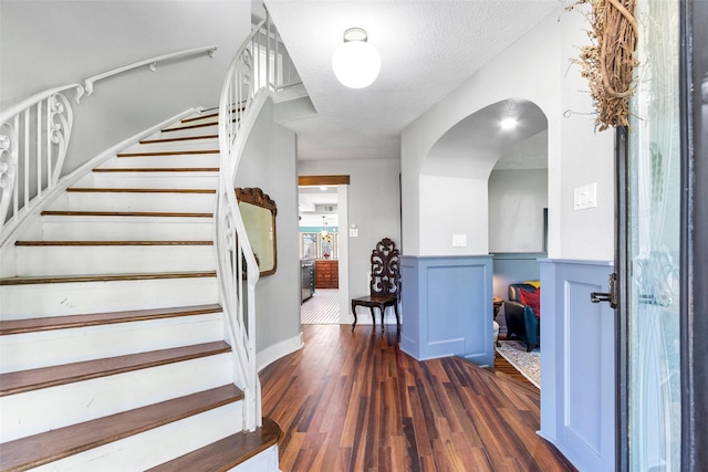 15407 Oaklawn Park Dr, Houston, TX 77069 - foyer entrance featuring stairway, wood finished floors, and arched walkways