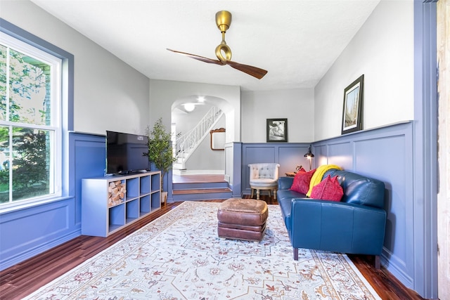 15407 Oaklawn Park Dr, Houston, TX 77069 - living area with a decorative wall, wood finished floors, healthy amount of natural light, arched walkways, and a wainscoted wall