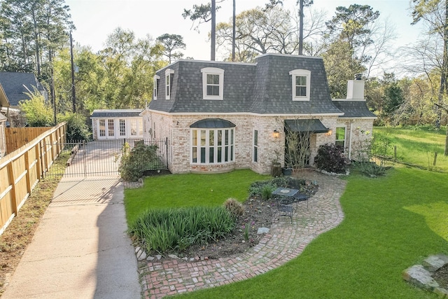 15407 Oaklawn Park Dr, Houston, TX 77069 - view of front of home with mansard roof, roof with shingles, brick siding, a gate, and a chimney