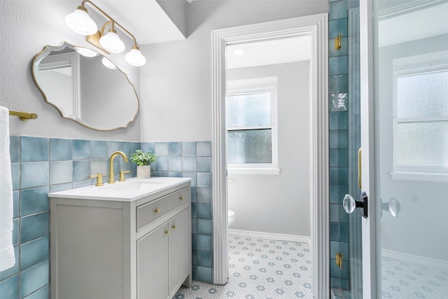 15407 Oaklawn Park Dr, Houston, TX 77069 - bathroom featuring vanity, tile walls, and wainscoting