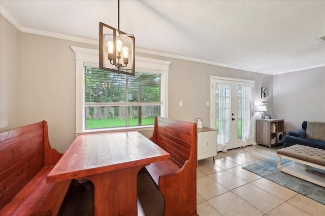 dining area with crown molding, tile patterned floors, a notable chandelier, and visible vents