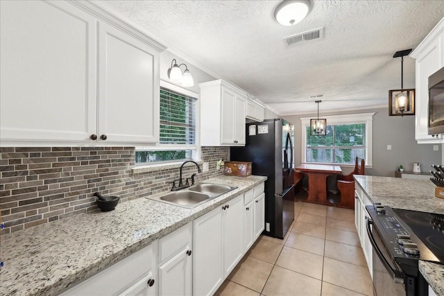 kitchen featuring tasteful backsplash, a sink, stainless steel fridge with ice dispenser, black range with electric cooktop, and white cabinetry