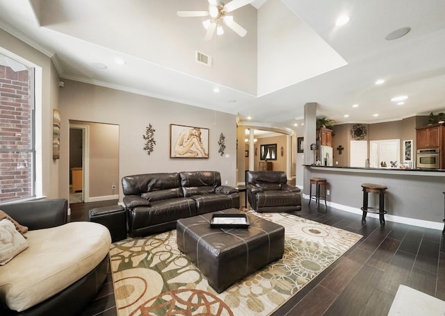 15502 Kellan Ct, Cypress, TX 77429 - living area with a ceiling fan, ornamental molding, dark wood-style flooring, baseboards, and arched walkways