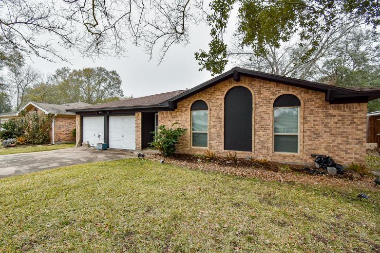 2116 Monterrey St, Kemah, TX 77565 - single story home featuring a front yard, an attached garage, brick siding, and driveway
