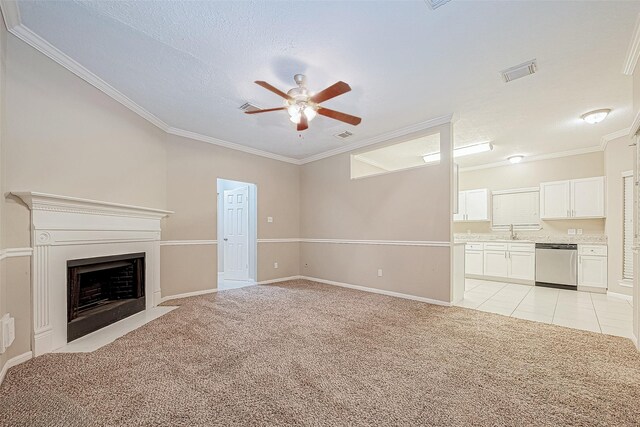 21403 Park Post Ln, Katy, TX 77450 - unfurnished living room featuring a ceiling fan, light carpet, crown molding, a fireplace with flush hearth, and a textured ceiling