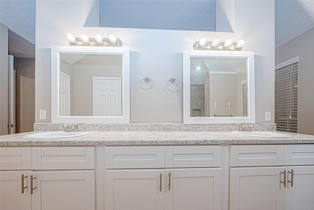 21403 Park Post Ln, Katy, TX 77450 - full bathroom featuring double vanity and a textured ceiling