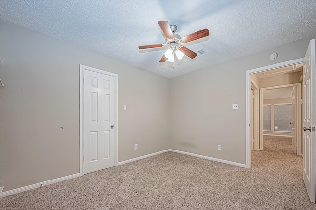 21403 Park Post Ln, Katy, TX 77450 - unfurnished room with light carpet, attic access, ceiling fan, and a textured ceiling