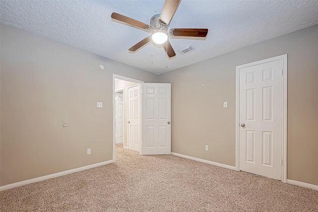 21403 Park Post Ln, Katy, TX 77450 - unfurnished bedroom with light carpet, a textured ceiling, and a ceiling fan