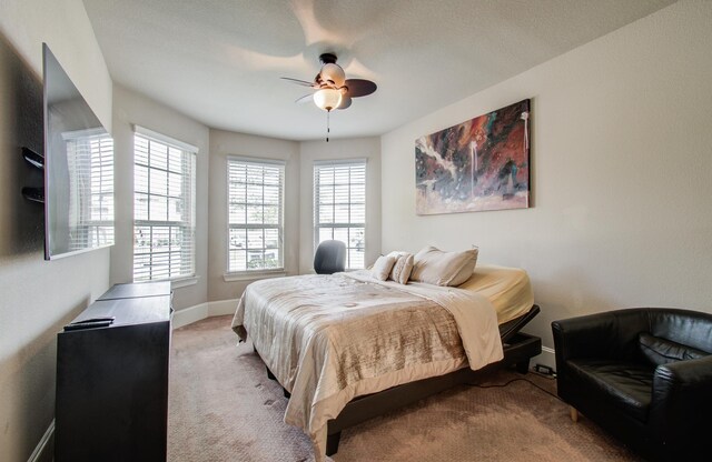 bedroom featuring baseboards, ceiling fan, and carpet flooring