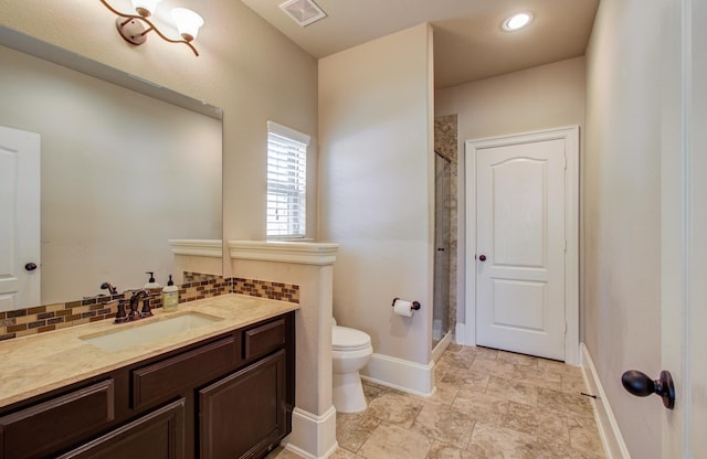 full bathroom featuring visible vents, backsplash, a shower stall, baseboards, and toilet