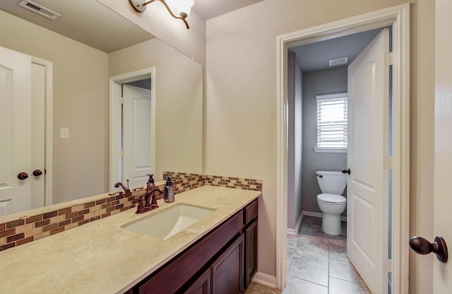 bathroom featuring tile patterned floors, visible vents, toilet, tasteful backsplash, and vanity
