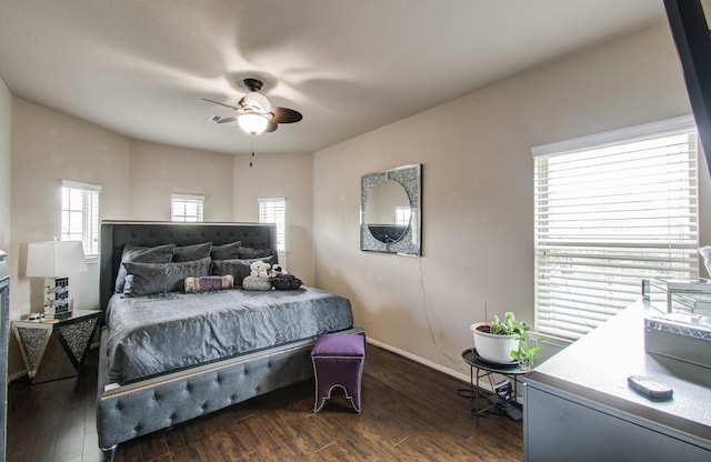 bedroom featuring a ceiling fan, baseboards, and dark wood-style flooring