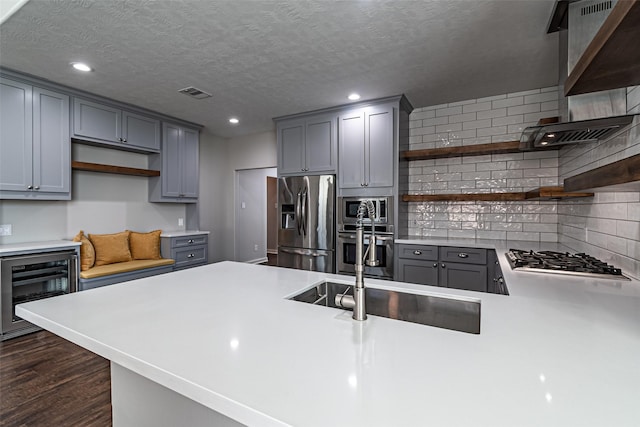 kitchen featuring visible vents, gray cabinetry, beverage cooler, appliances with stainless steel finishes, and open shelves