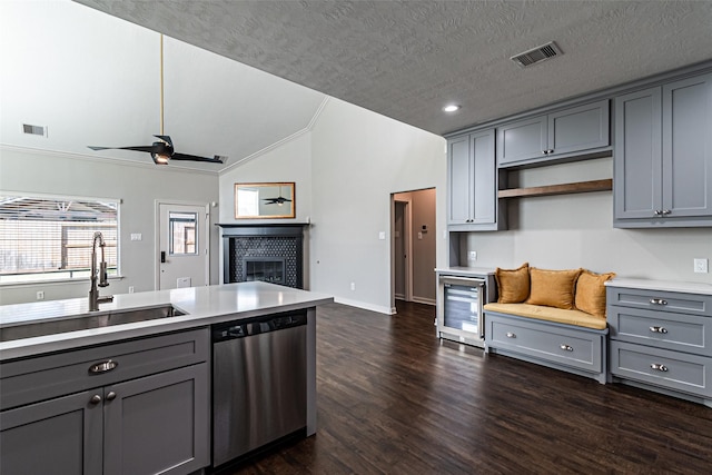 kitchen featuring stainless steel dishwasher and gray cabinets