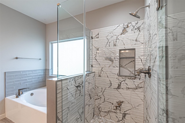 full bath featuring a garden tub and a shower stall