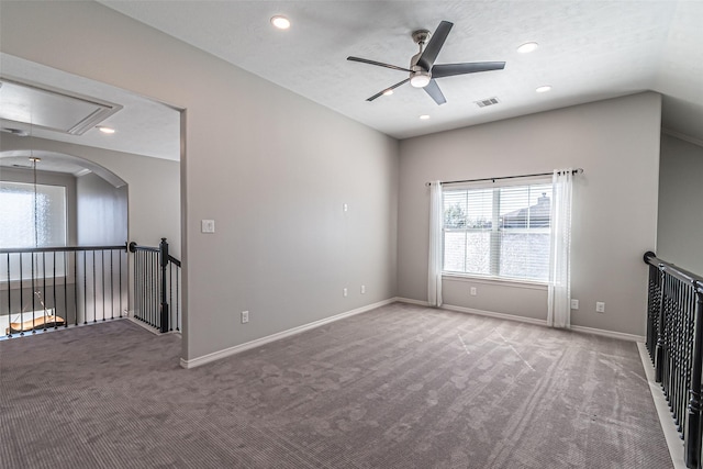 carpeted empty room featuring visible vents, baseboards, attic access, recessed lighting, and a ceiling fan