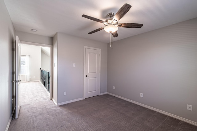 unfurnished bedroom featuring carpet flooring, ceiling fan, and baseboards